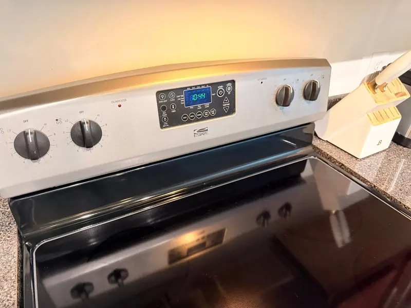 Glass-top range with a clean stainless control panel and a wiped cooktop
