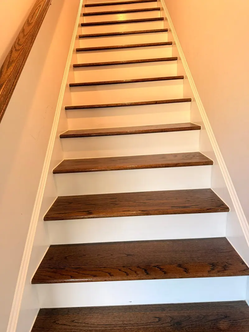 Wood stair treads with white risers, dusted and wiped