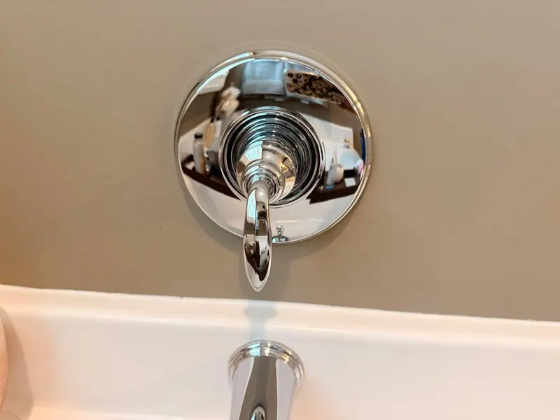 Polished chrome tub faucet and handle after a bathroom deep clean